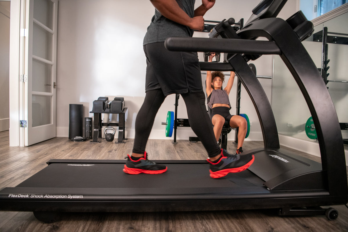 Runner on the Life Fitness Run CX treadmill in a home gym